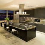 A green kitchen from top to bottom cabinets to floors